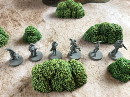 Monster Fight Club's Verdant Green Bushes, shown alongside their Cyberpunk Red miniatures (shown for scale only, not included)
