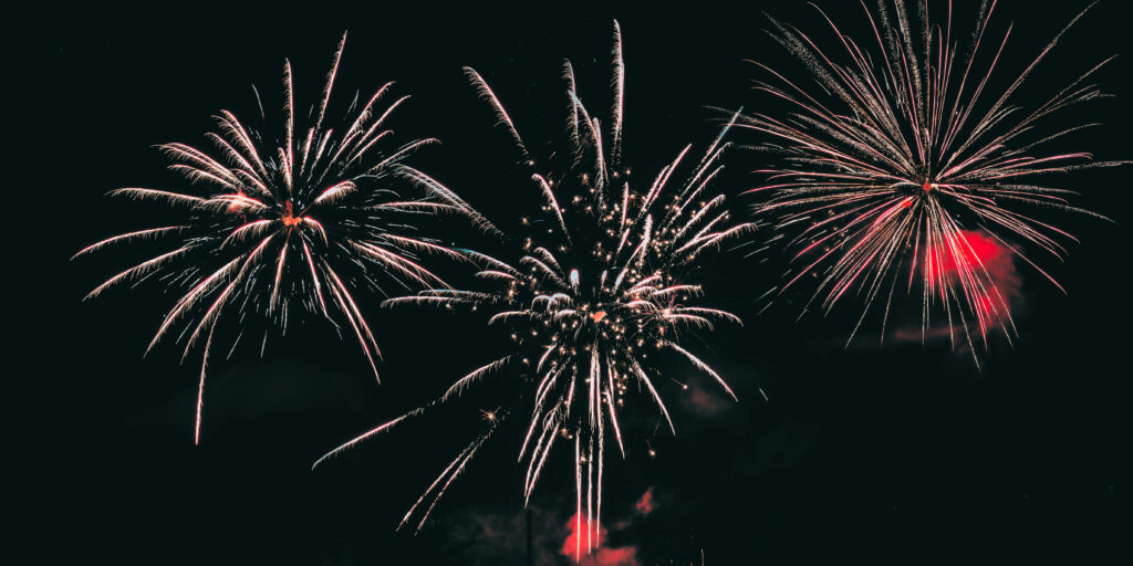 Fireworks, three exploding high in the sky